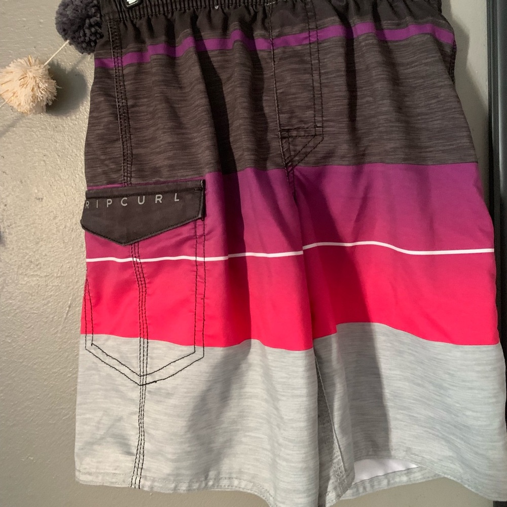 Boys black and pink rip curl swim shorts